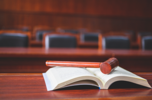 law book with gavel on top in a court room