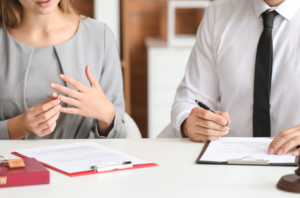 Woman and man going through the divorce process, looking at divorce papers.